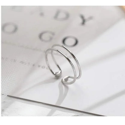Adjustable silver plated geometric cross ring for women in gold tone or silver tone on a copper base.