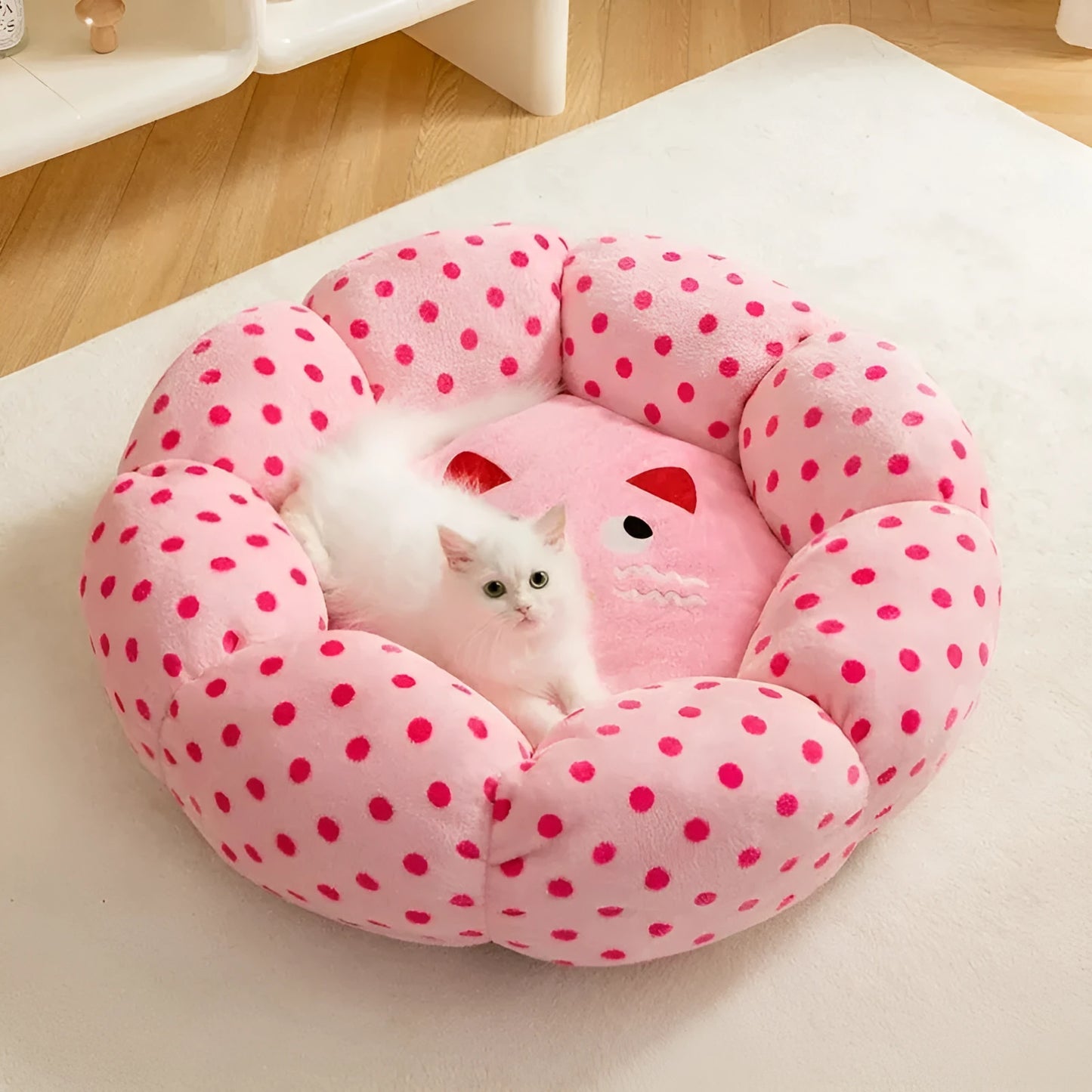 Pink dot pattern fabric cat bed shown in two size options: 45cm and 65cm diameter.