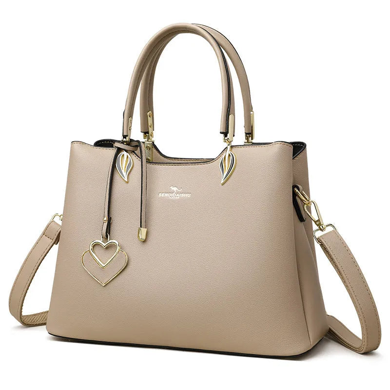 Women's black PU leather messenger bag with multi-layer shoulder strap and sewing thread detailing.