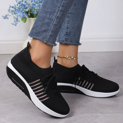 Women's red platform sneakers with mesh upper and front lace-up design on rubber sole