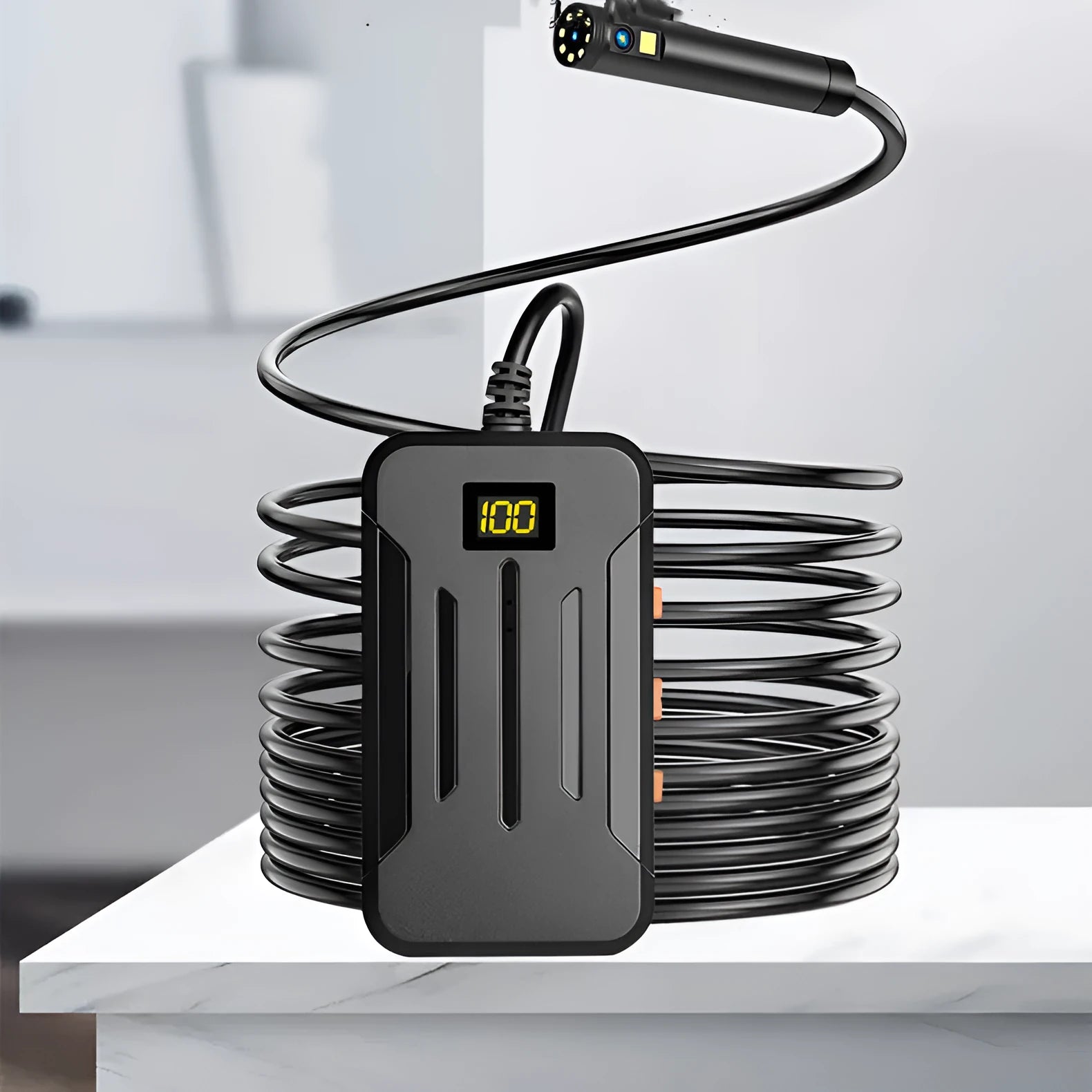 Wireless dual-lens inspection endoscope with IP68 waterproof probe, magnet, and hook accessories on a table.
