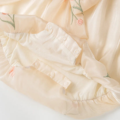 Apricot-coloured sleeveless baby jumpsuit with triangle design on hanger