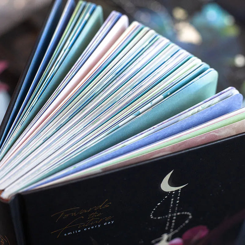 A5 notebook with luminous cover in Deep Blue, open to show 100 gsm paper and colour illustrations