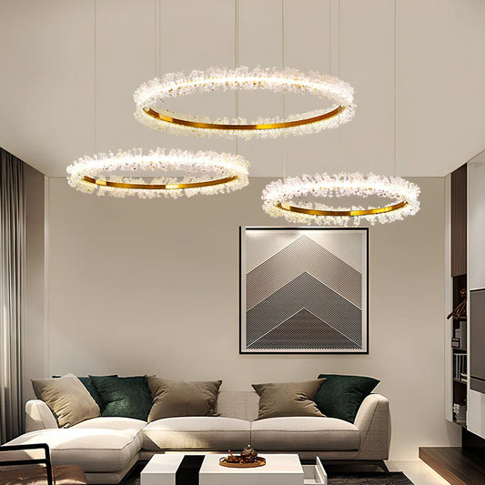 Gold electroplated crystal chandelier with remote control, adjustable height mechanism, and multiple LED lights