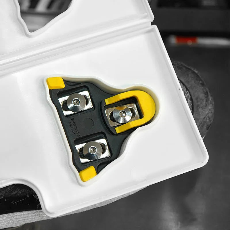 Locking plate adjustment tool for bicycle cleats on a workbench.