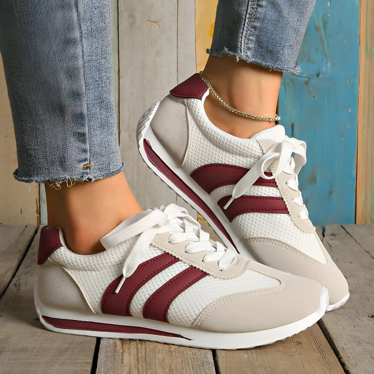 Wine red retro sneakers with cross-strap detail and breathable mesh surface
