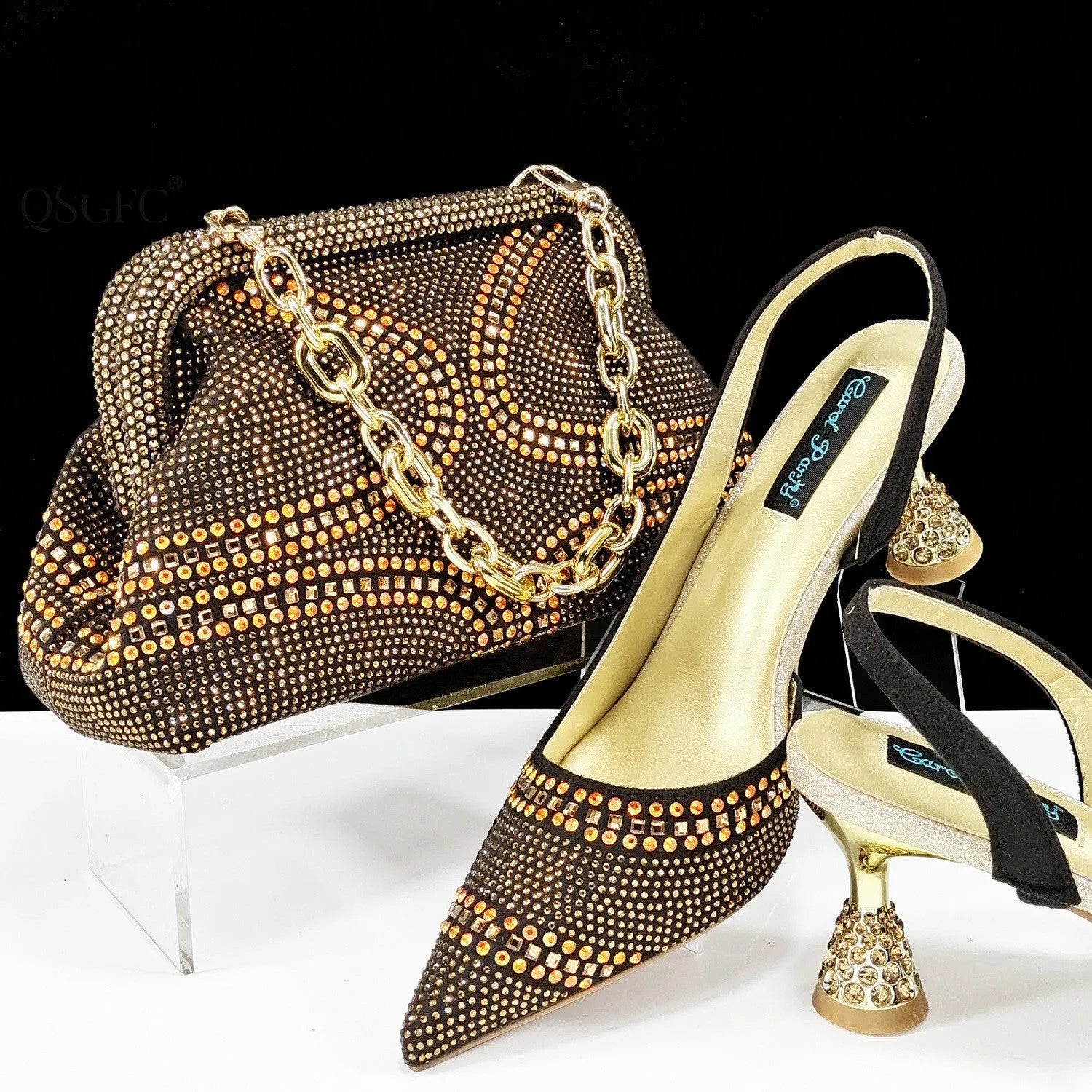 Women's pointed toe high heel court shoes in blue with rhinestone detail and a matching small bag.