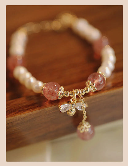 Women's adjustable Strawberry Quartz crystal bracelet with bow charm on wrist