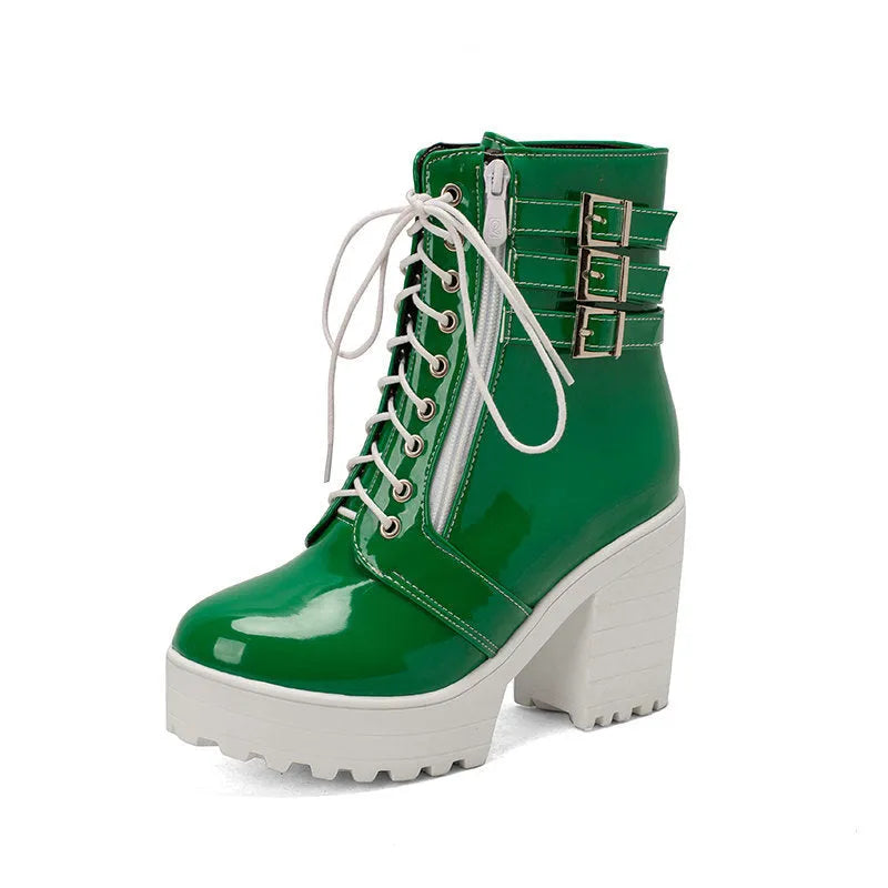 Women's black lace-up ankle boots with a round toe and thick 6-8cm platform heel on a wooden floor.