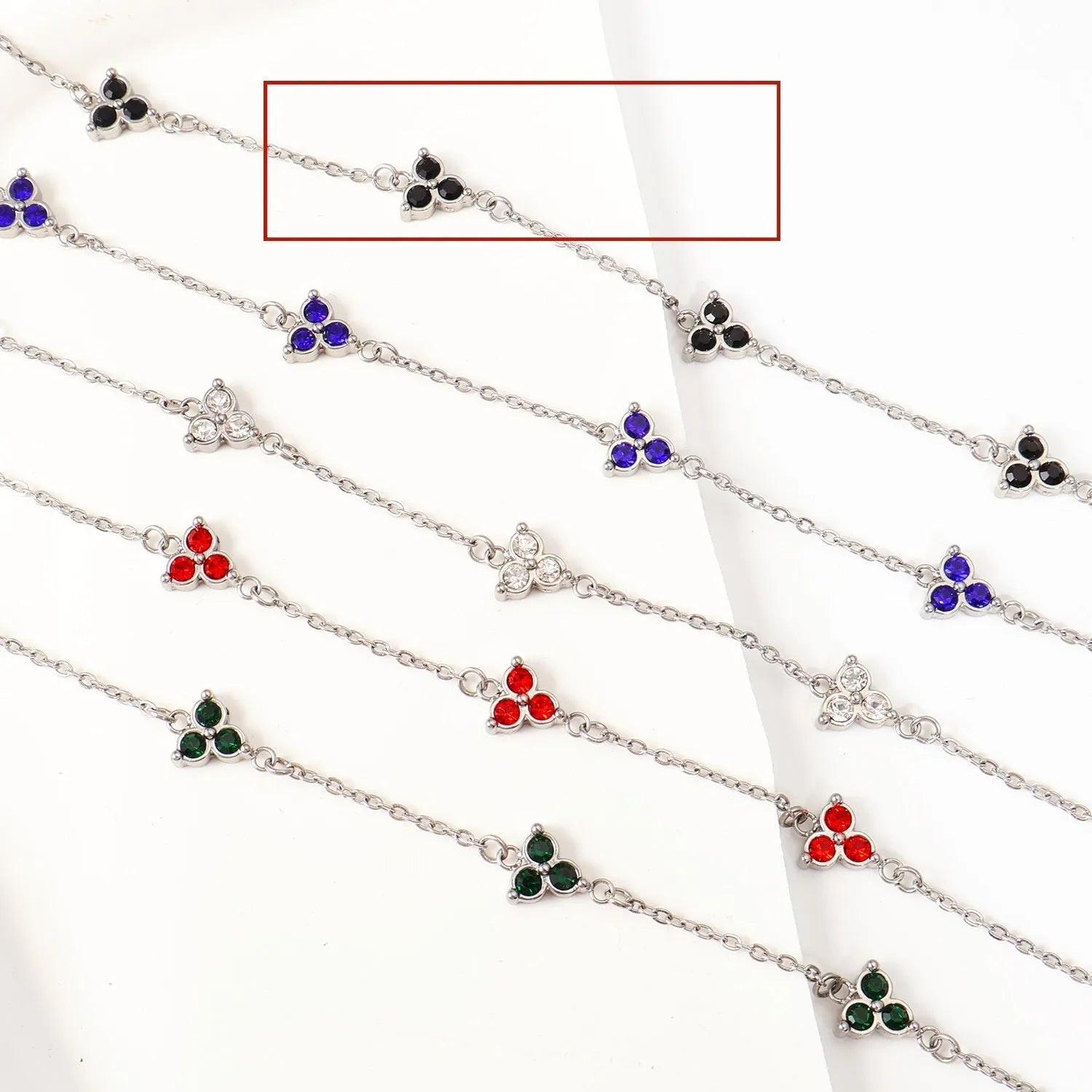 Women's stainless steel bracelet with three triangle-shaped charms in different coloured stone settings