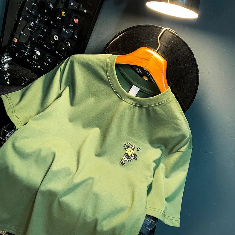 Green men's loose fit t-shirt with 'Literary Youth' text print on the front.
