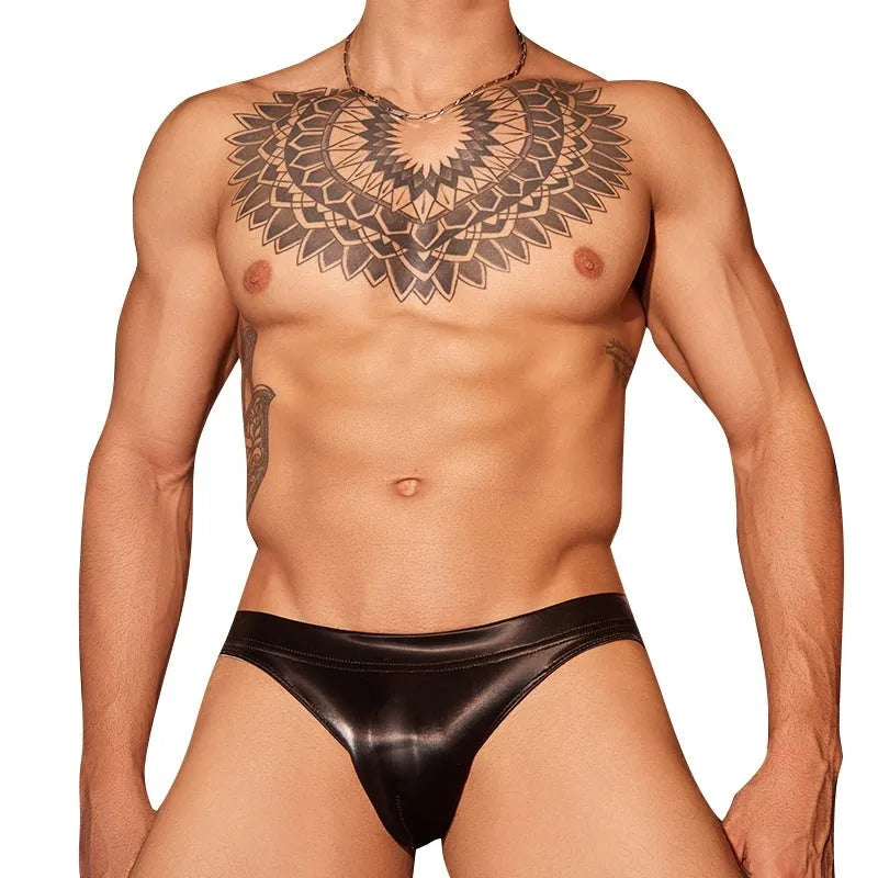 Men's black shark skin lace briefs on a white background, showing textured hipster design.