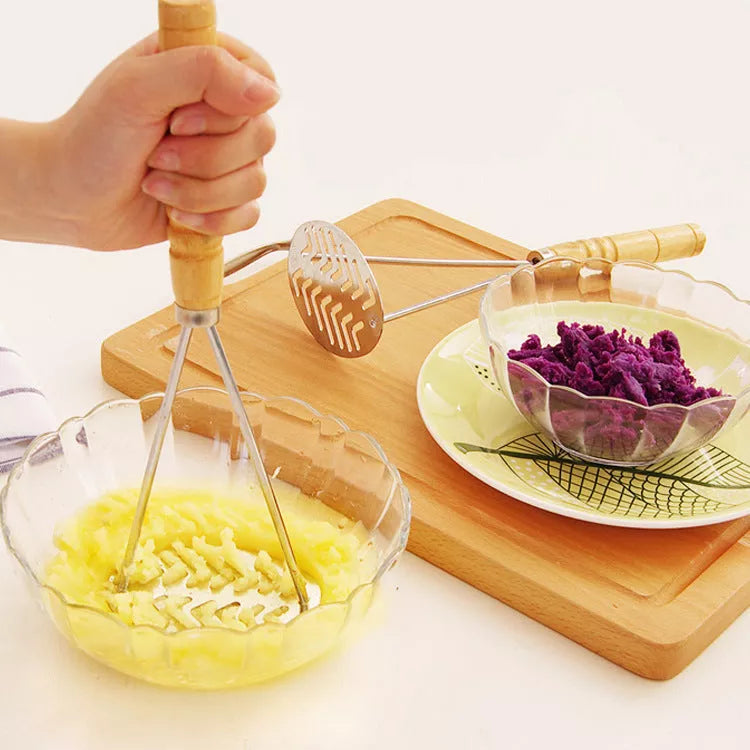Manual potato masher with wooden handle and flower-shaped press for easy mashing