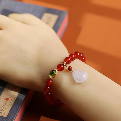 Handcrafted red agate bracelet with amber beads, jade accents, and Maitreya Buddha pendant in Chinese geometric style
