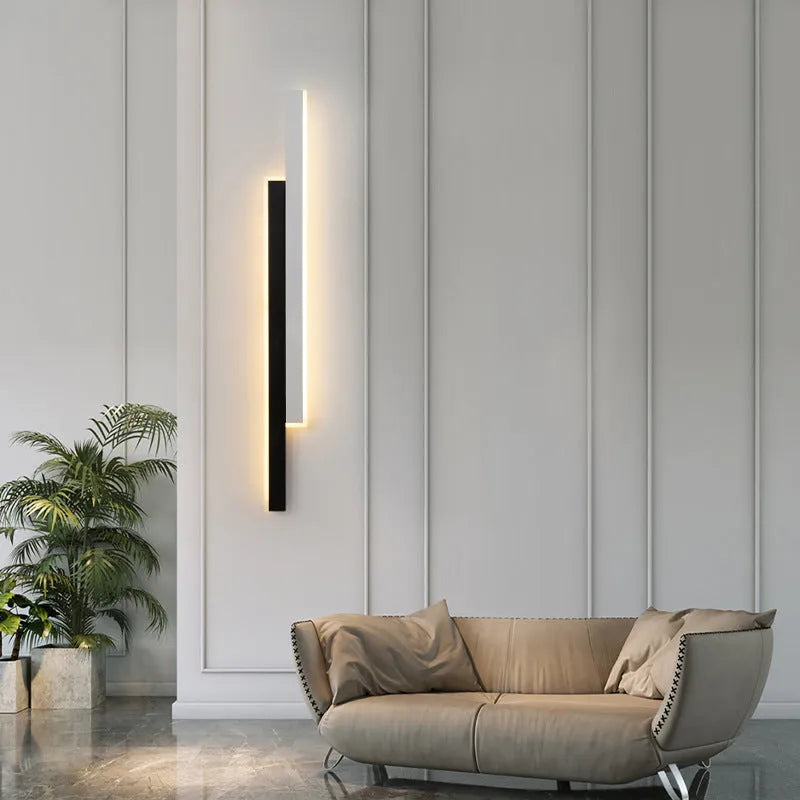 Modern strip wall lamp with acrylic shade mounted beside bed