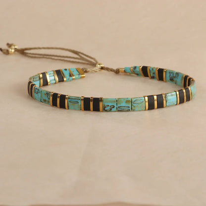 Adjustable pull beads glass bracelet in geometric shapes, shown in milky white colour.