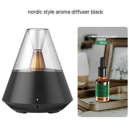 Compact black aroma diffuser humidifier with remote control on wooden surface