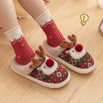 Cozy elk-inspired plush slippers in festive Christmas green and red colors, featuring a soft, comfortable upper and non-slip soles for indoor wear