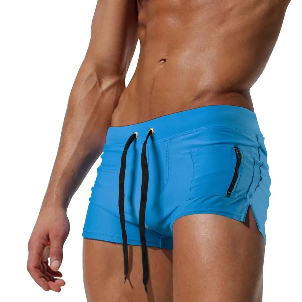 Men's black high-waisted swimming trunks with a white lace-up front closure, laid flat.