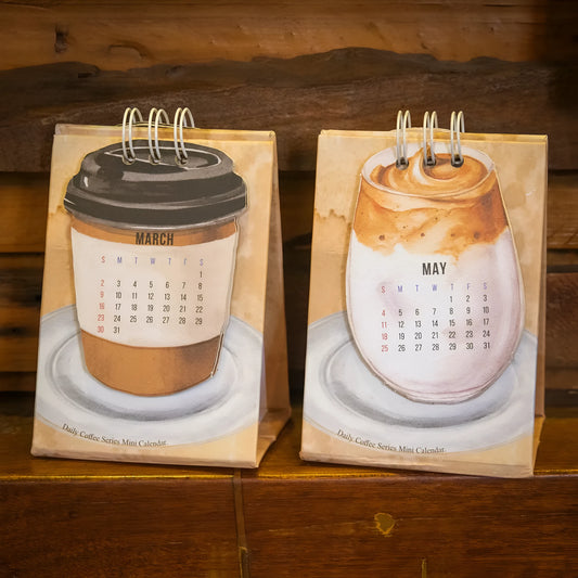 2025 mini desk calendar showing one of four designs: Coffee Time, Awake Time, Corner Perching, or Afternoon Lazy.