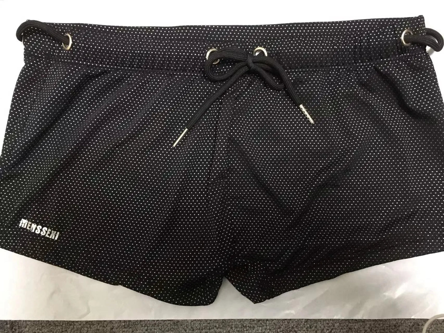 Men's low waist boxer style swimming trunks in nylon, available in multiple solid colours.