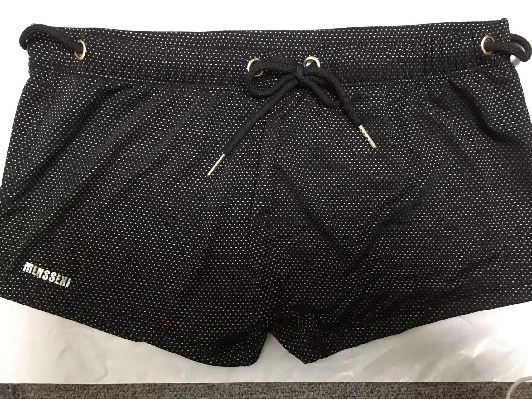 Men's low waist boxer style swimming trunks in nylon, available in multiple solid colours.