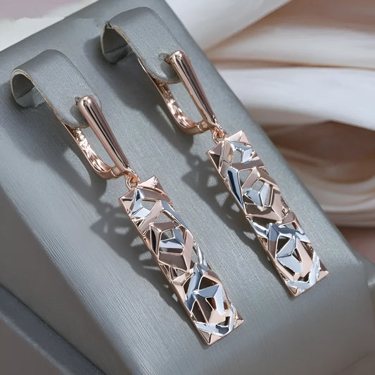 Rectangular two-tone hollow stud earrings with a geometric design and electroplated finish.
