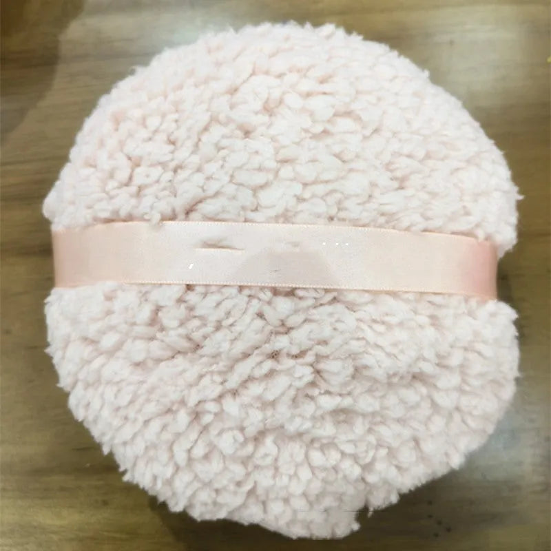 Oversized plush dry puff for makeup powder application in white colour, measuring 150mm by 75mm