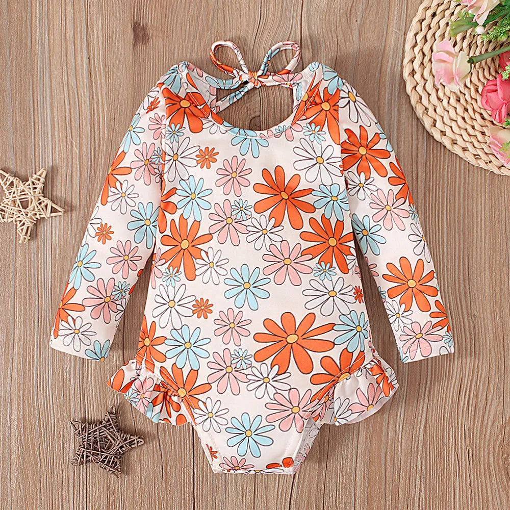 Girl's floral print swimsuit with crew neck and open back design in polyester fabric