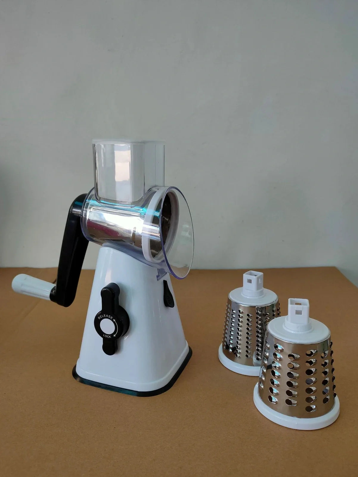 White plastic hand drum vegetable cutter slicer showing drum mechanism for even 0.5 cm vegetable slices, compact 20 cm size