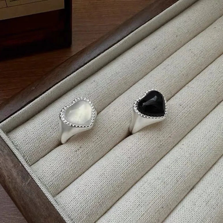 S925 sterling silver ring with a polished black heart-shaped agate stone on an adjustable open band.
