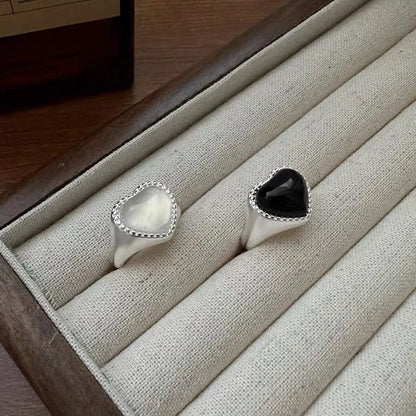 S925 sterling silver ring with a polished black heart-shaped agate stone on an adjustable open band.