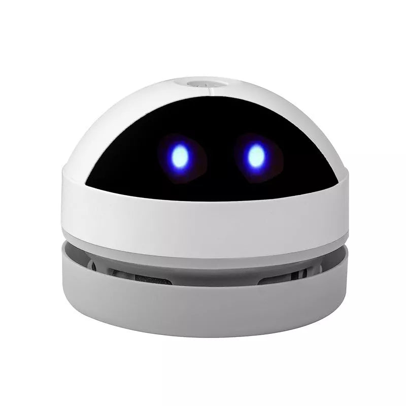 Compact USB charging wireless mini portable robot desktop vacuum cleaner on a desk