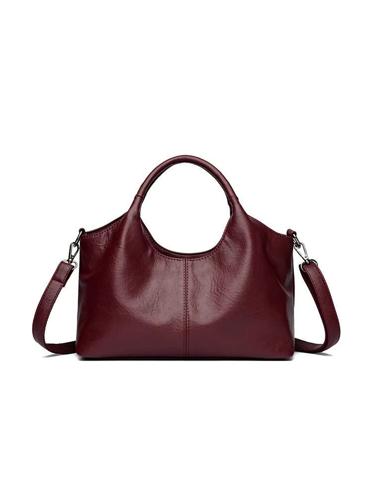Soft genuine leather women's crossbody bag in beige with large capacity and adjustable strap.