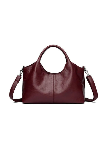 Soft genuine leather women's crossbody bag in beige with large capacity and adjustable strap.