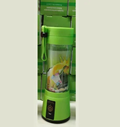 Compact pink portable blender with USB charging cable and box, shown alongside blended fruit smoothie.
