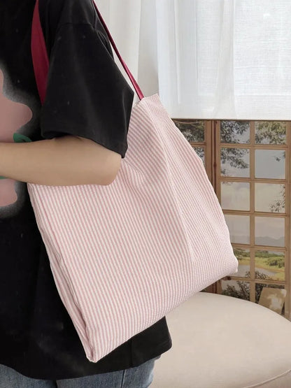 Light pink striped cotton canvas multi-layer tote bag with a wide shoulder strap.