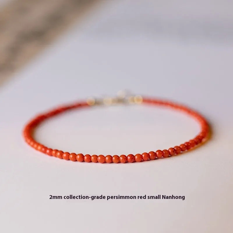 Close-up of a women's retro bracelet with a Southern Red Agate stone in cherry red on a wrist.