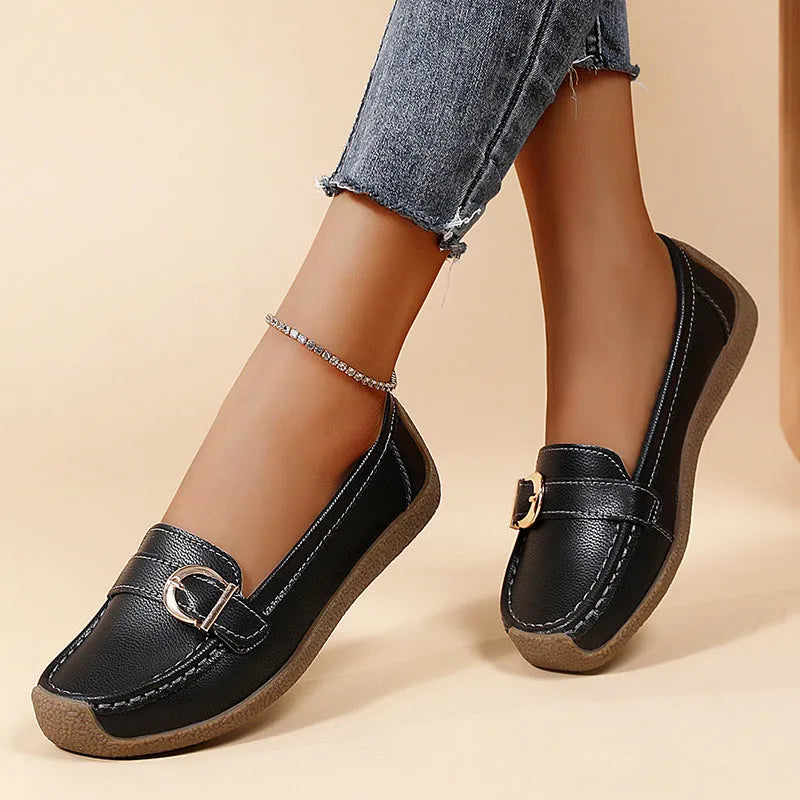 Women's beige casual loafers with round toe and flat heel on a white background.