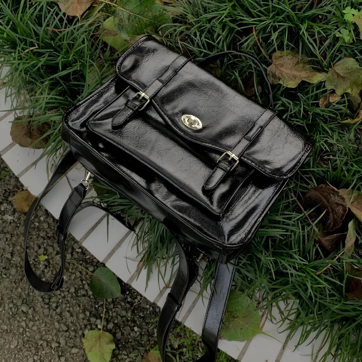 Black college style messenger bag made from PU leather with shoulder strap