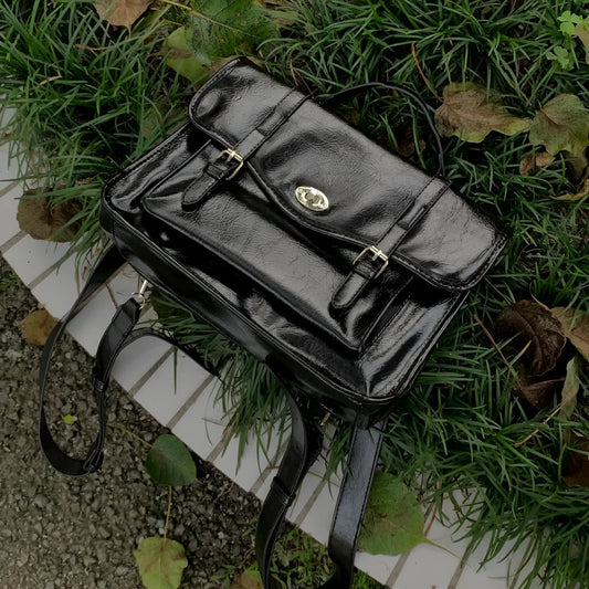 Black college style messenger bag made from PU leather with shoulder strap