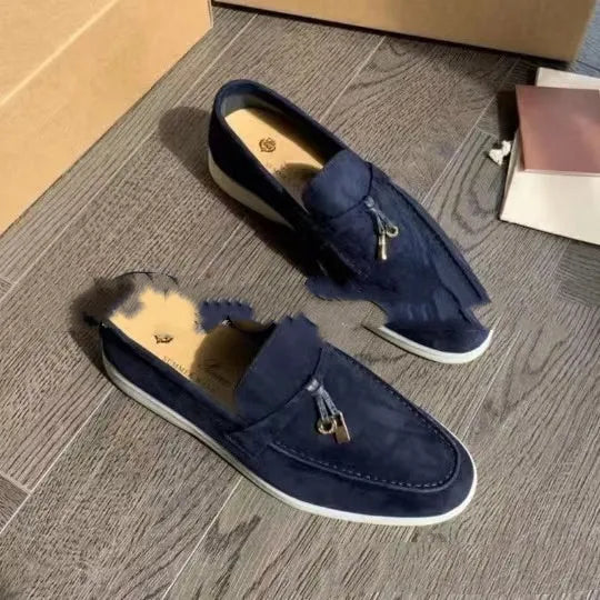 High top slip-on loafers in black with round toe and sewing line detail on a rubber sole.