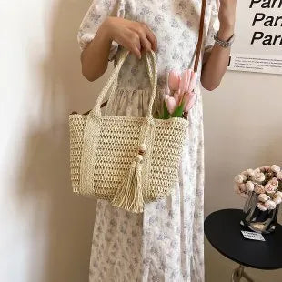 Women's large capacity straw crossbody bag in milky white or khaki with soft woven body and shoulder strap