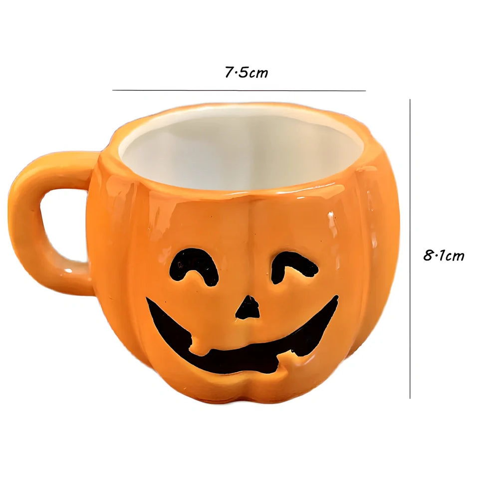 Orange ceramic Halloween pumpkin mug with cartoon face and included spoon on autumn table