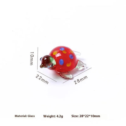 Geometric glass turtle figurine ornament on a desk, shown in blue head and blue shell colour variant.