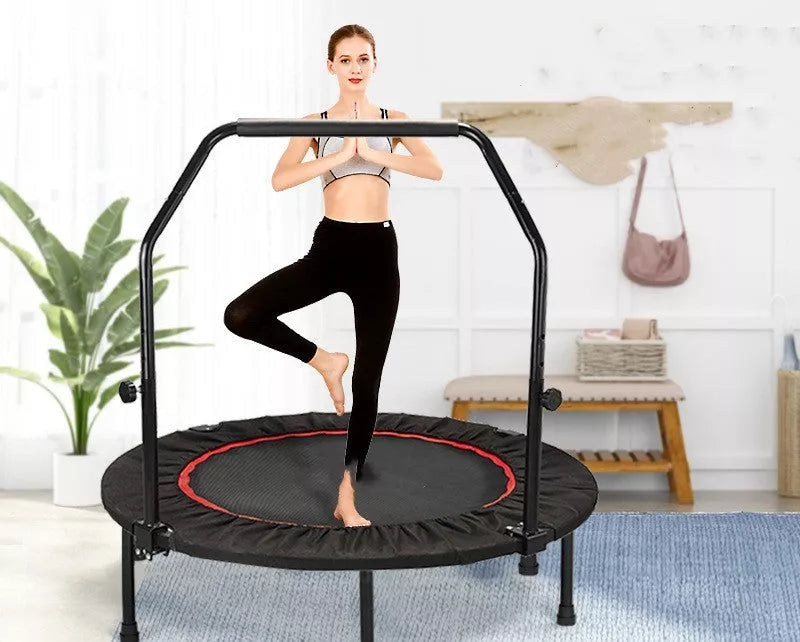 Red and black indoor trampoline with optional safety handrail for kids and adults