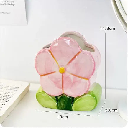 Ceramic floral pen holder showing blue flowers pattern, measuring 11.8cm wide by 10cm high