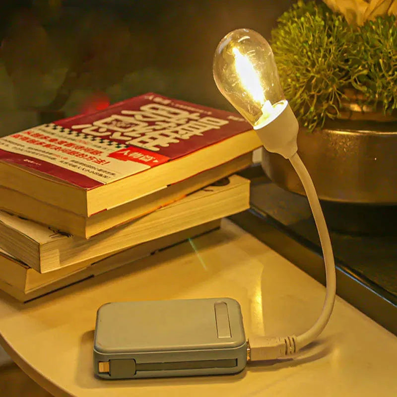 USB rechargeable folding night light with tungsten filament bulb showing warm white illumination