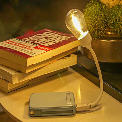 USB rechargeable folding night light with tungsten filament bulb showing warm white illumination