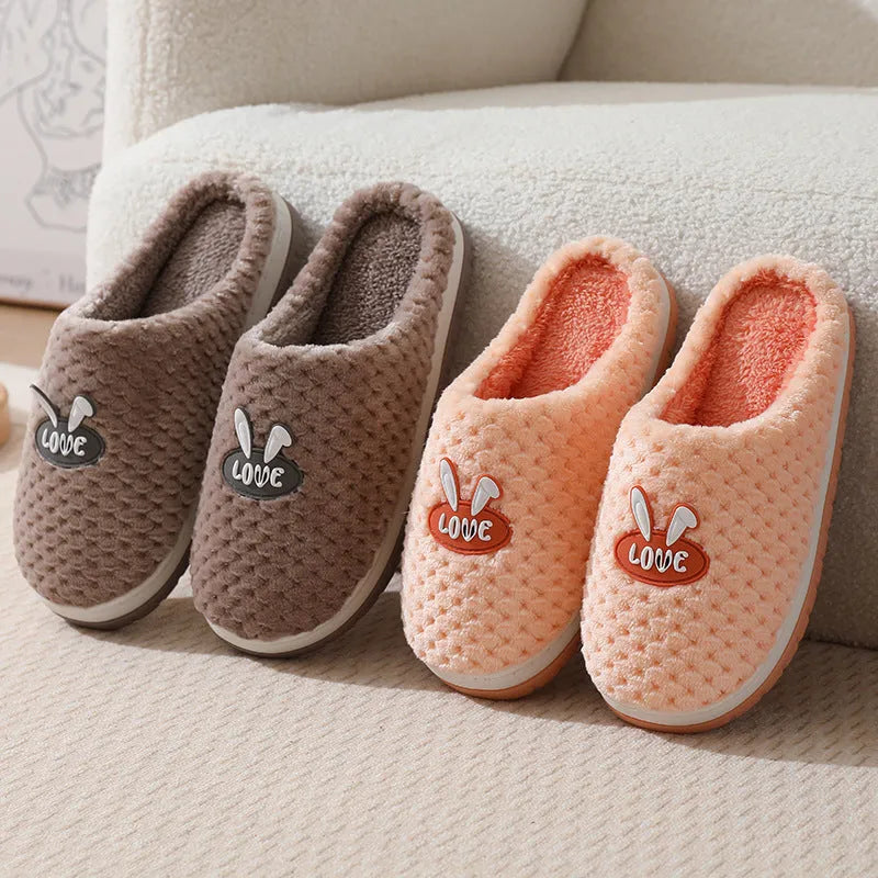 Women's plush rabbit plaid design winter slippers with a thick light-coloured rubber sole.